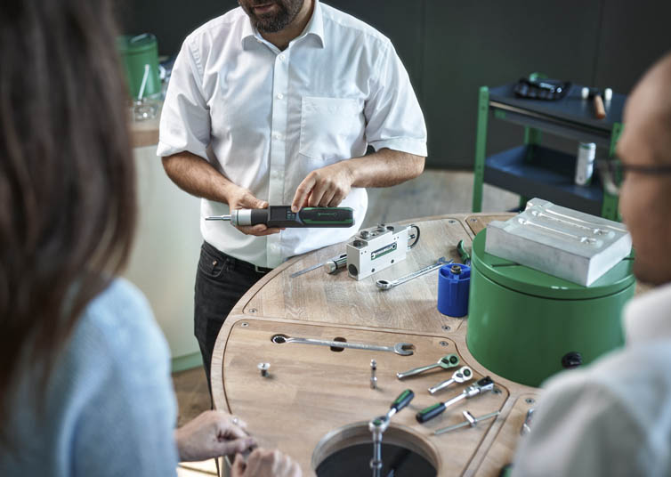 A STAHLWILLE employee explains different tools to two customers during an on-site product training session