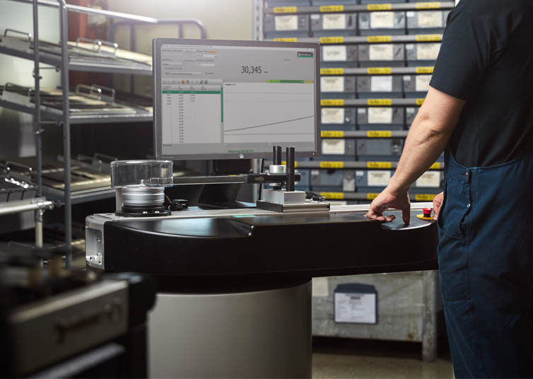 Employee performs calibration of a torque wrench on the computer