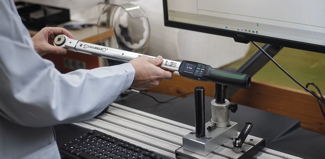Torque wrench is being calibrated on a calibration system