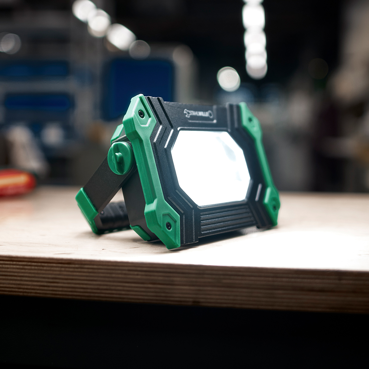 A work spotlight is on a workbench